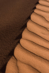 Closeup of desert sand dunes pattern of shadows