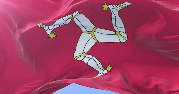 Flag of the Isle of Man waving at wind with blue sky in slow, loop