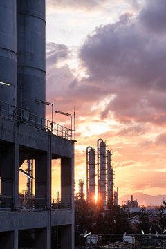 Gas distillation tower in petrochemical plant at sunrise