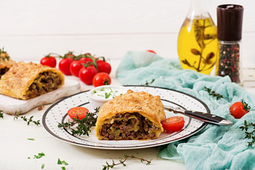 Appetizing strudel with minced beef, onions and herbs