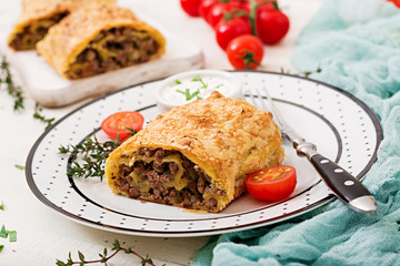 Appetizing strudel with minced beef, onions and herbs