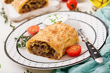 Appetizing strudel with minced beef, onions and herbs