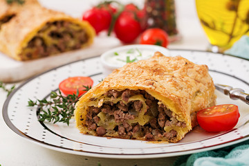 Appetizing strudel with minced beef, onions and herbs