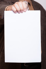 Businessman holding blank sheet of paper. Business concept.