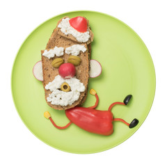 Happy Santa made with vegetables and bread on plate