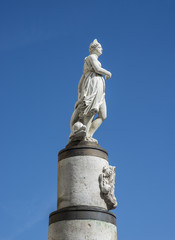 Statue of Mariblanca. This is a copy located at Puerta del Sol, carved in 1985, replica of the original designed by Ludovico Turqui. It is a female figure relate to the fertility Venus or Fortuna.