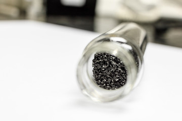 activated carbon or granular in clear bottle is used in air purification, decaffeinate, gold purification, metal extraction, water purification, medicine, sewage treatment, air filters in gas masks