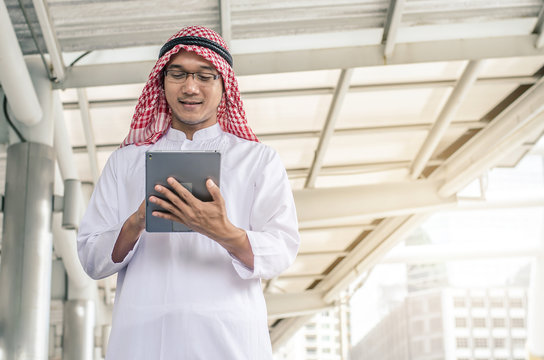 A handsome arab business man hold and browsing a digital tablet