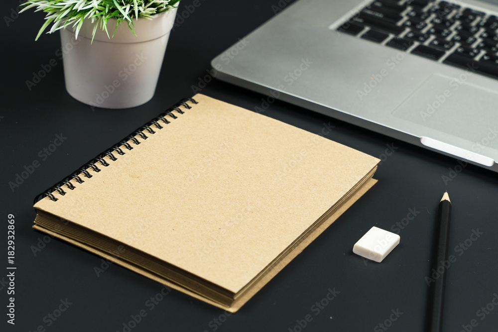 Poster Business office work desk table with computer laptop , note and stationery on black table background include copyspace for add text or graphic