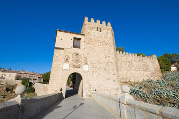 Fototapeta na wymiar medieval bridge and St Martin gate, landmark and monument from nineteenth century, in Toledo city, Spain, Europe 