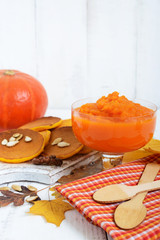 Delicate dietary pumpkin puree on a white wooden background. Healthy food. Proper nutrition.
