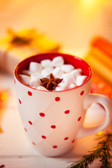 Cup of hot Chocolate drink. Cocoa with Marshmallows and cinnamon on wooden background with Christmas decorations.