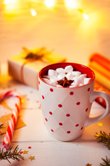 Cup of hot Chocolate drink. Cocoa with Marshmallows and cinnamon on wooden background with Christmas decorations.