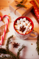 Cup of hot Chocolate drink. Cocoa with Marshmallows and cinnamon on wooden background with Christmas decorations.