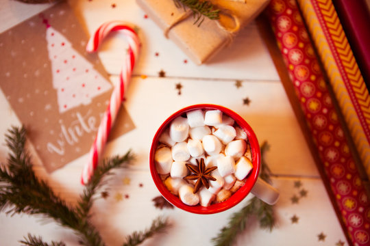 Cup of hot Chocolate drink. Cocoa with Marshmallows and cinnamon on wooden background with Christmas decorations.