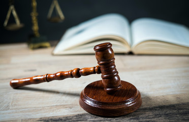 Golden scales of justice, gavel and books on brown background, Law code