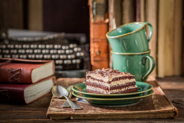 Homemade cake and coffee with books and typewriter