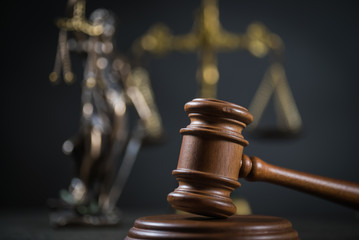 Golden scales of justice, gavel and books on brown background, Law code