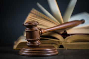 Golden scales of justice, gavel and books on brown background, Law code