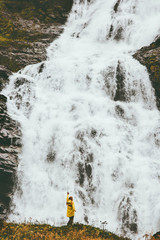 Woman tourist sightseeing big waterfall outdoor Travel Lifestyle adventure concept scandinavian vacations