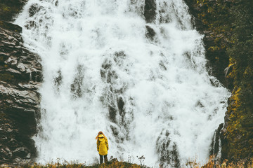 Woman enjoying big waterfall landscape view outdoor Travel Lifestyle concept adventure scandinavian vacations in Norway