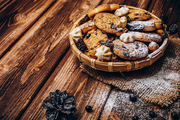 Tasty fresh baked cookies with berries on the wooden table