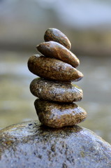 Zen stones stack from large to small on the river