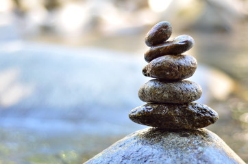 Zen stones stack from large to small on the river