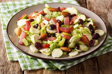 Healthy food: salad from Brussels sprouts, cranberries, almonds and ham close-up. horizontal