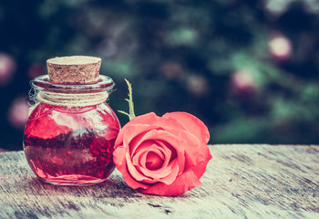 Essential rose oil in a glass bottle. Love elixir. Love potion.