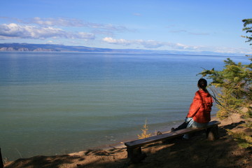 Fototapeta premium Woman looks at lake Baikal