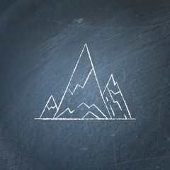 Mountain peaks icon on chalkboard