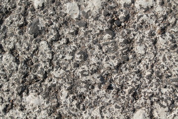 Granite rock closeup background, stone texture, cracked surface