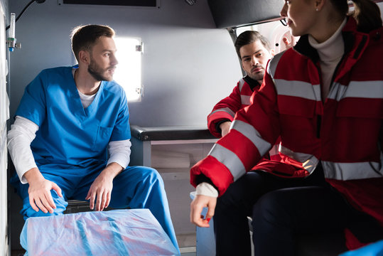 Three ambulance doctors sitting in a car