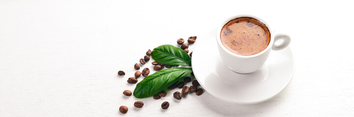 A cup of coffee and coffee beans on a wooden background. Top view. Free space for text. - obrazy, fototapety, plakaty