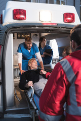 paramedics moving injured man into ambulance © LIGHTFIELD STUDIOS