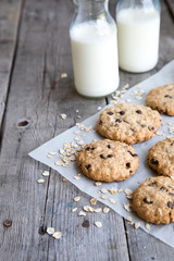 homemade oatmeal cookies with chocolate on an old wooden background