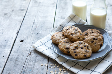 homemade oatmeal cookies with chocolate on an old wooden background