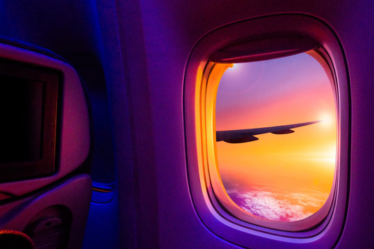 Beautiful scenic view of sunset through the aircraft window. Image save-path for window of airplane.