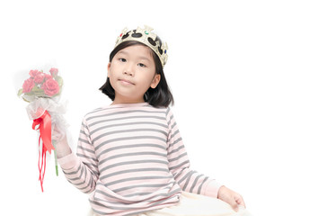 Cute asian girl wearing a crown and holding rose bouquet