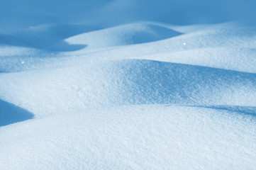 Fototapeta na wymiar Winter background of snowdrifts in the sunlight
