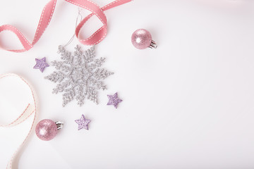 Christmas holiday composition. Festive creative gold silver pattern, xmas pink decor holiday ball with ribbon, snowflakes on white background. Flat lay, top view