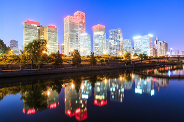 Fototapeta na wymiar Business district office buildings and water reflection in Beijing at night