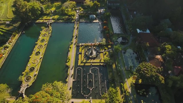 Hindu Balinese Water Palace Tirta Gangga on Bali island, Indonesia. Aerial view Tirta Gangga the former royal water palace is a maze of pools and fountains surrounded by a lush garden and stone