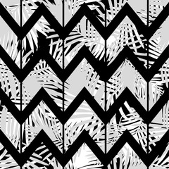 Naklejka premium Seamless background with decorative leaves. Zigzag texture. Pattern with Palm leaves. Textile rapport.