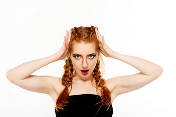 Pretty girl with red hair looks like a lion posing in the studio