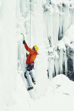 Ice climbing in the northern Caucasus. A man climbs the waterfall.