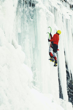 Ice climbing in the northern Caucasus. A man climbs the waterfall.