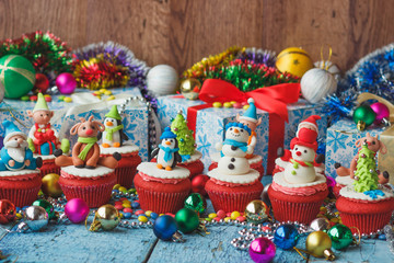Christmas cupcakes with colored decorations made from confectionery mastic