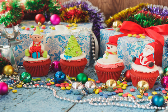 Christmas cupcakes with colored decorations made from confectionery mastic